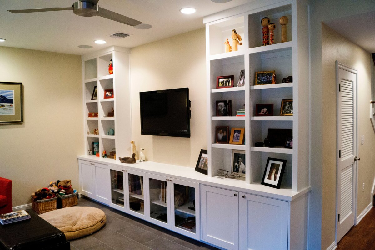 built-in bookshelf in family room. mounted TV in between bookshelf to ceiling.