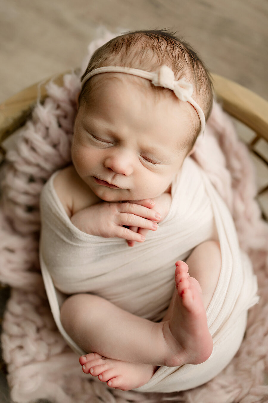 Swaddled baby girl posed for newborn pictures