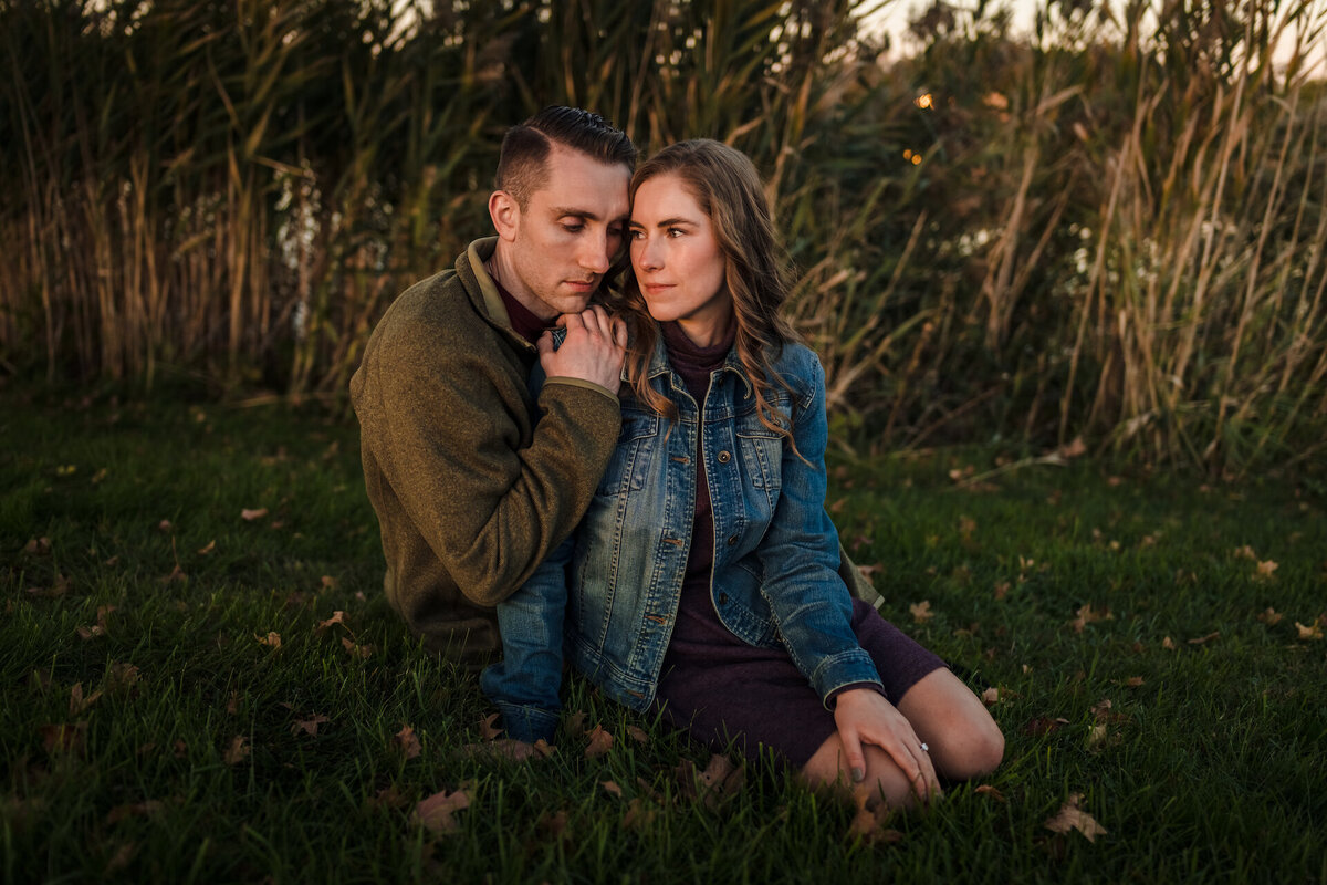 A couple sits in the grass  at Independence Grove In Libertyville, IL
