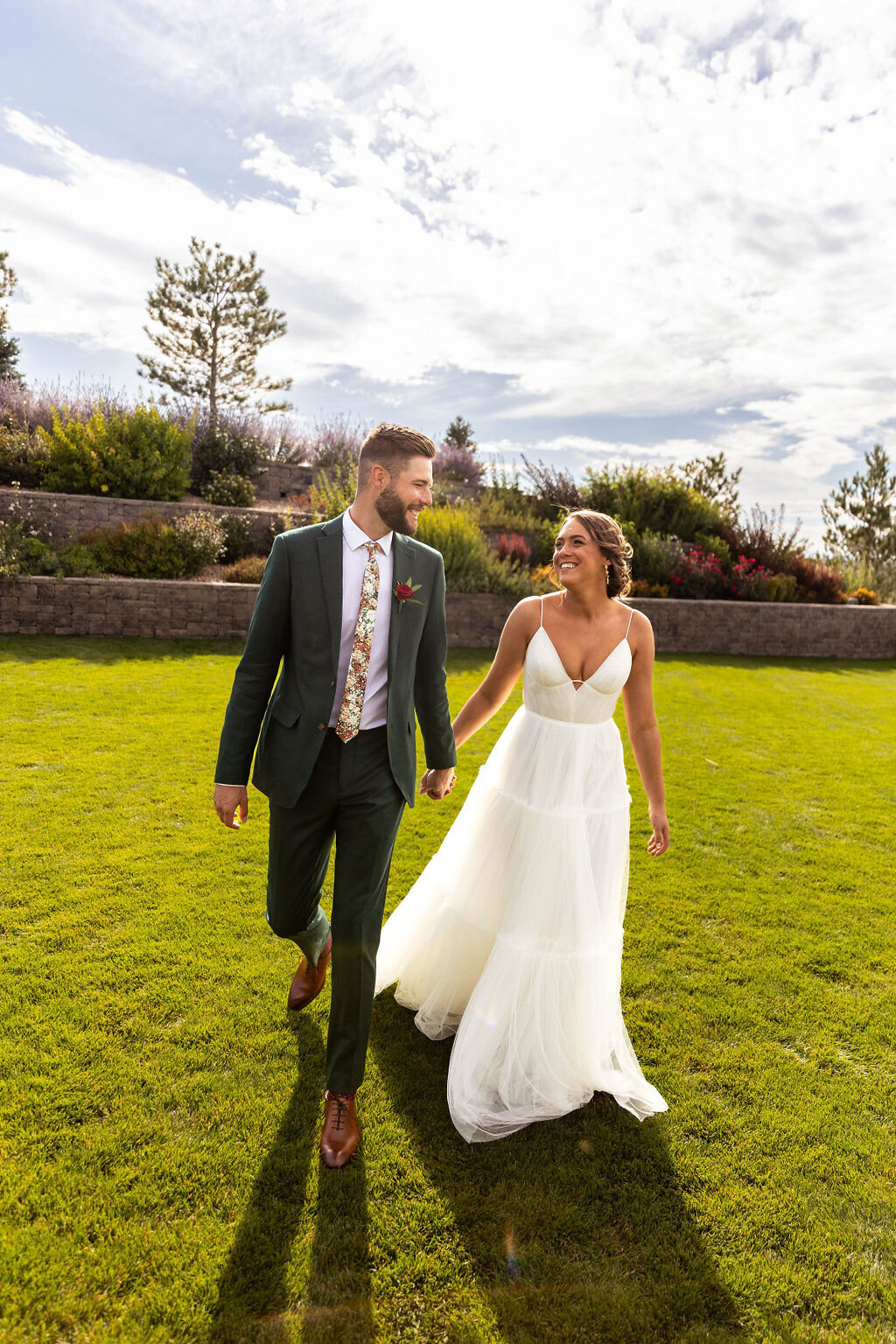 Bride and groom hold hands on their wedding day at Bonnie Blues Event Venue.