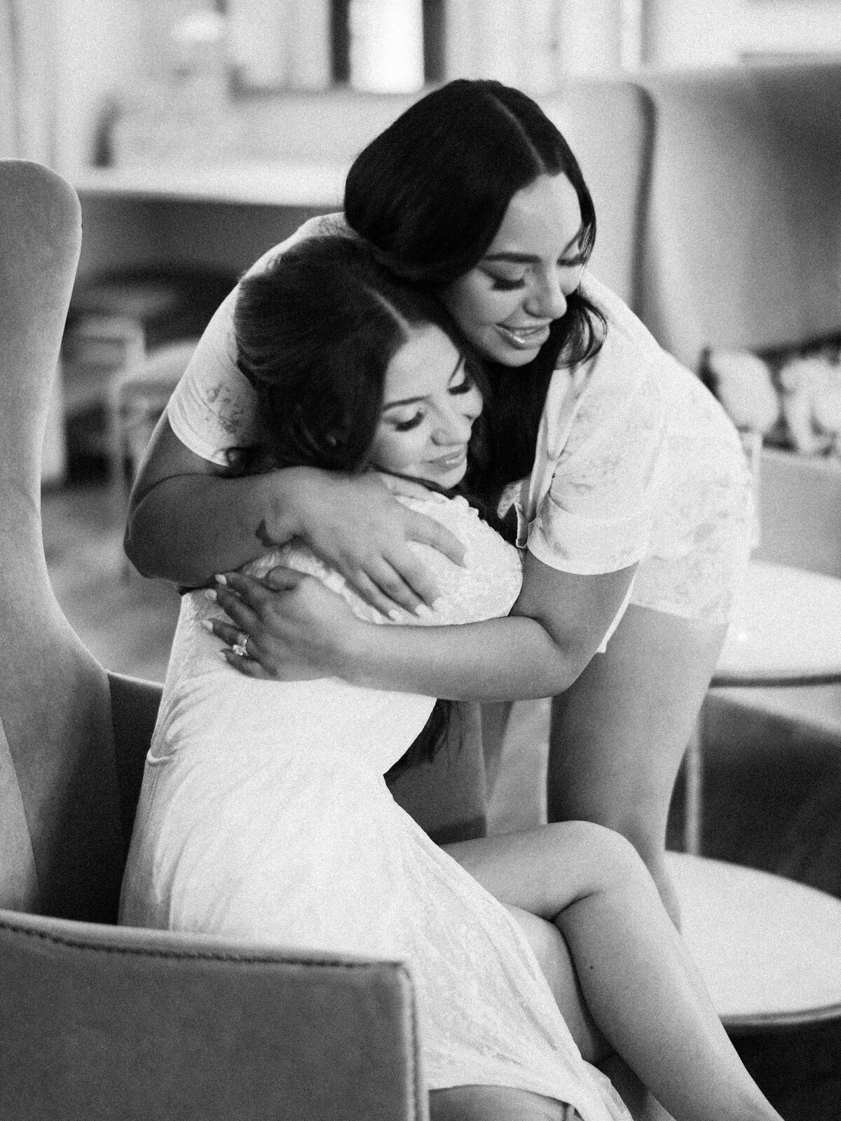 modern bride hugging maid of honor before ceremony