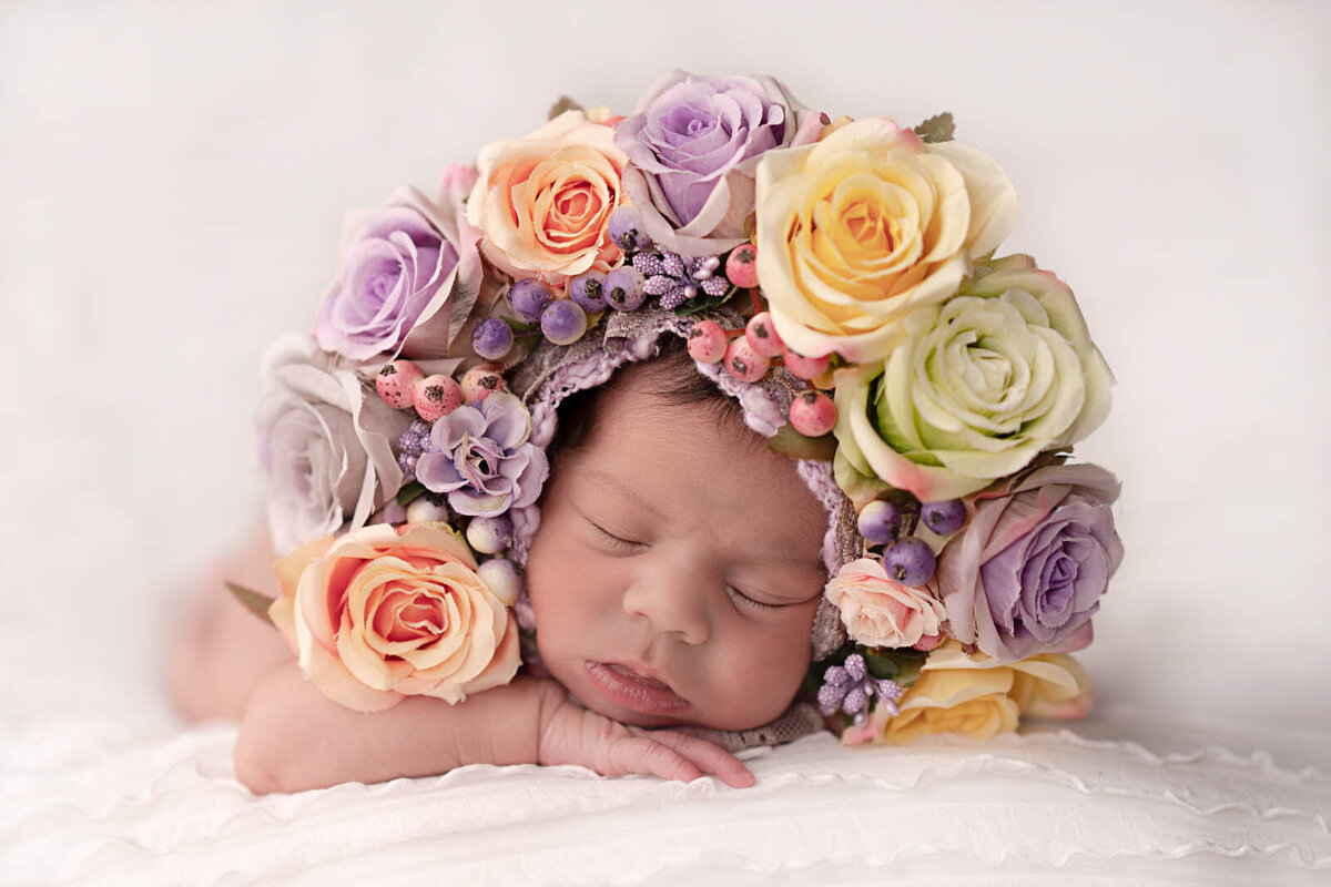 Newborn girl wearing flowers around her head