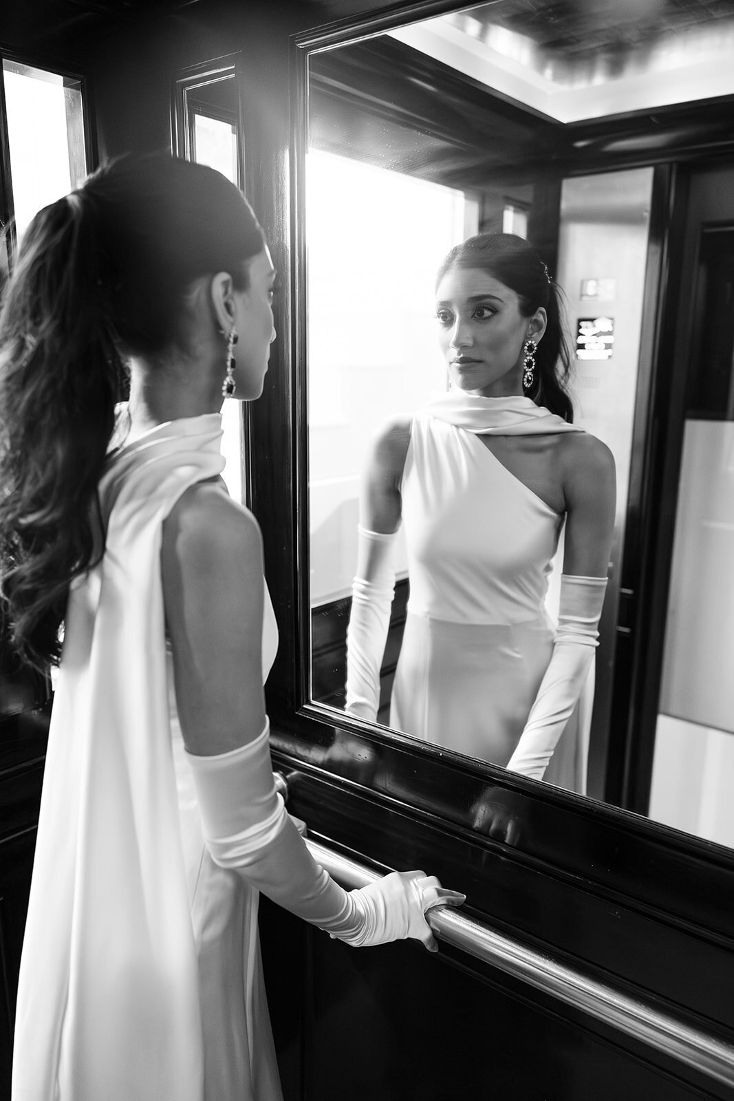 Bride posing at the Cap Estel mirors lift