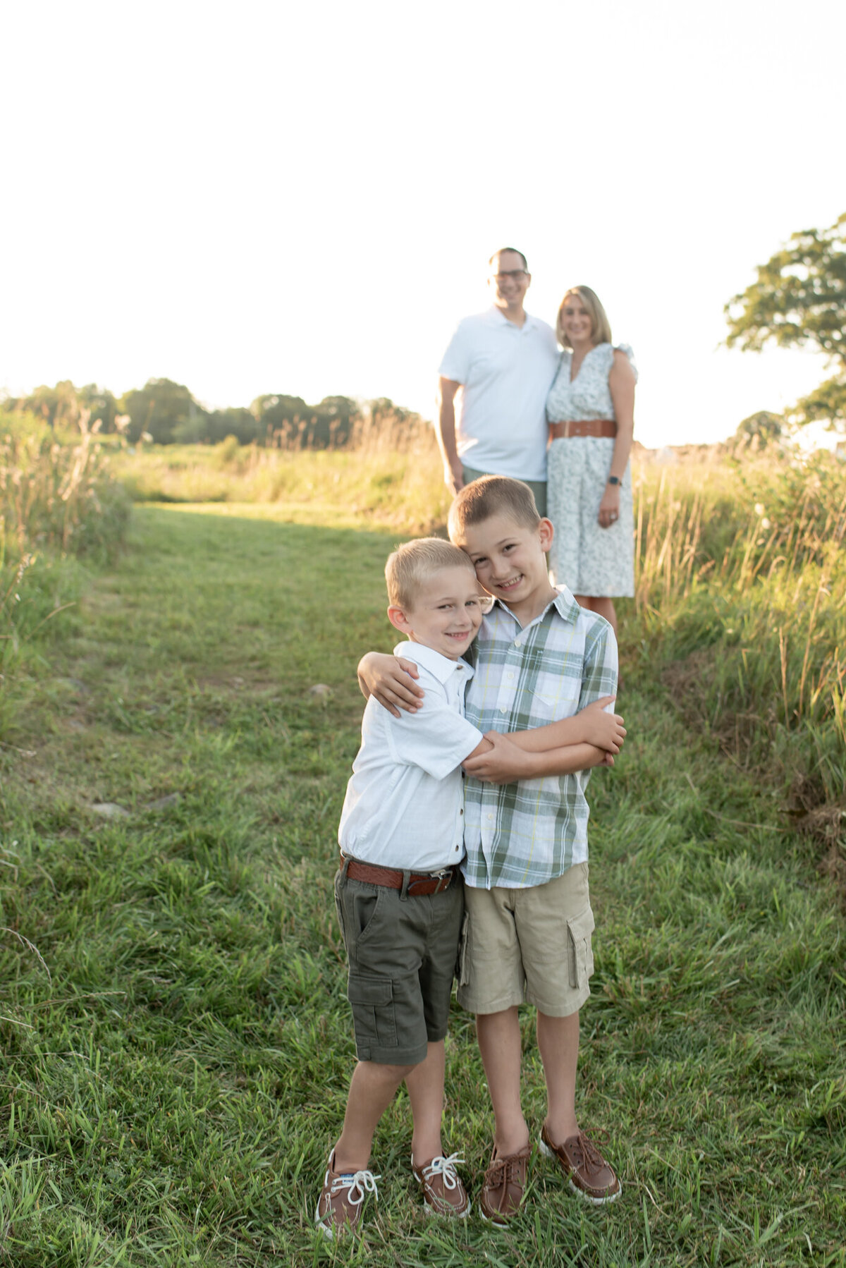 Family in field at sunset