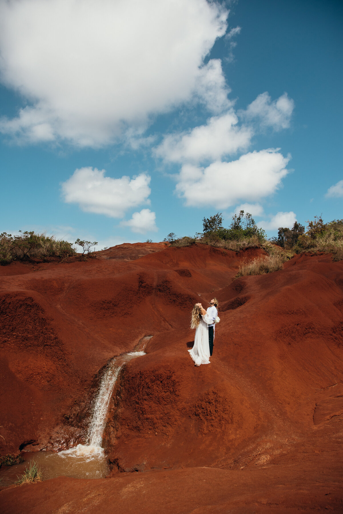 Maui Wedding Photographer captures bride and groom at red sand beach