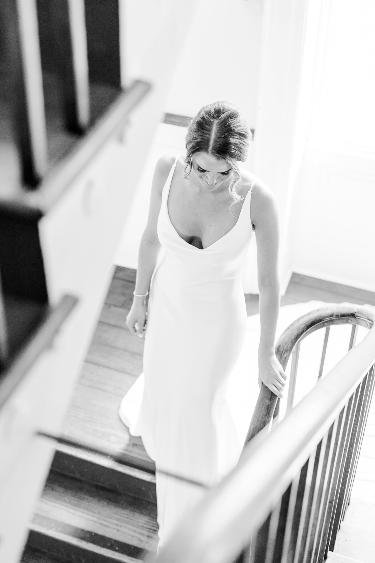bride walking down the stairs at the william aiken house