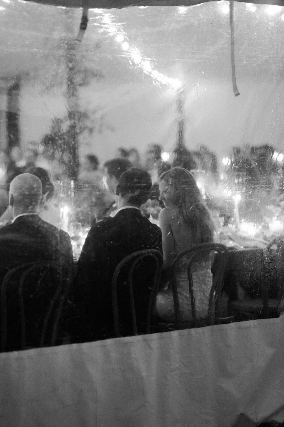 Newlyweds smile at each other during their reception 