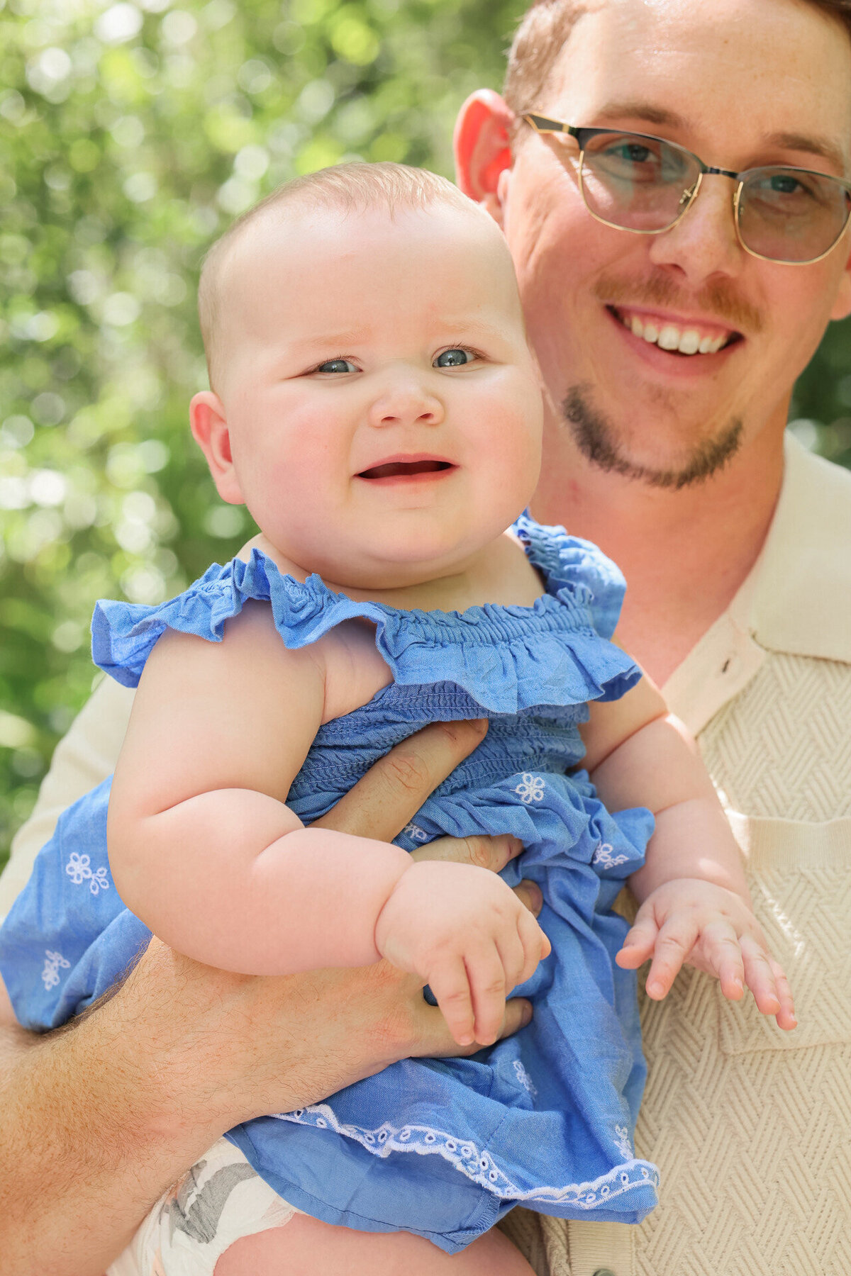 dad holding daughter wearing yellow and blue by Daytona Beach family photographer Amanda Richardson Photography