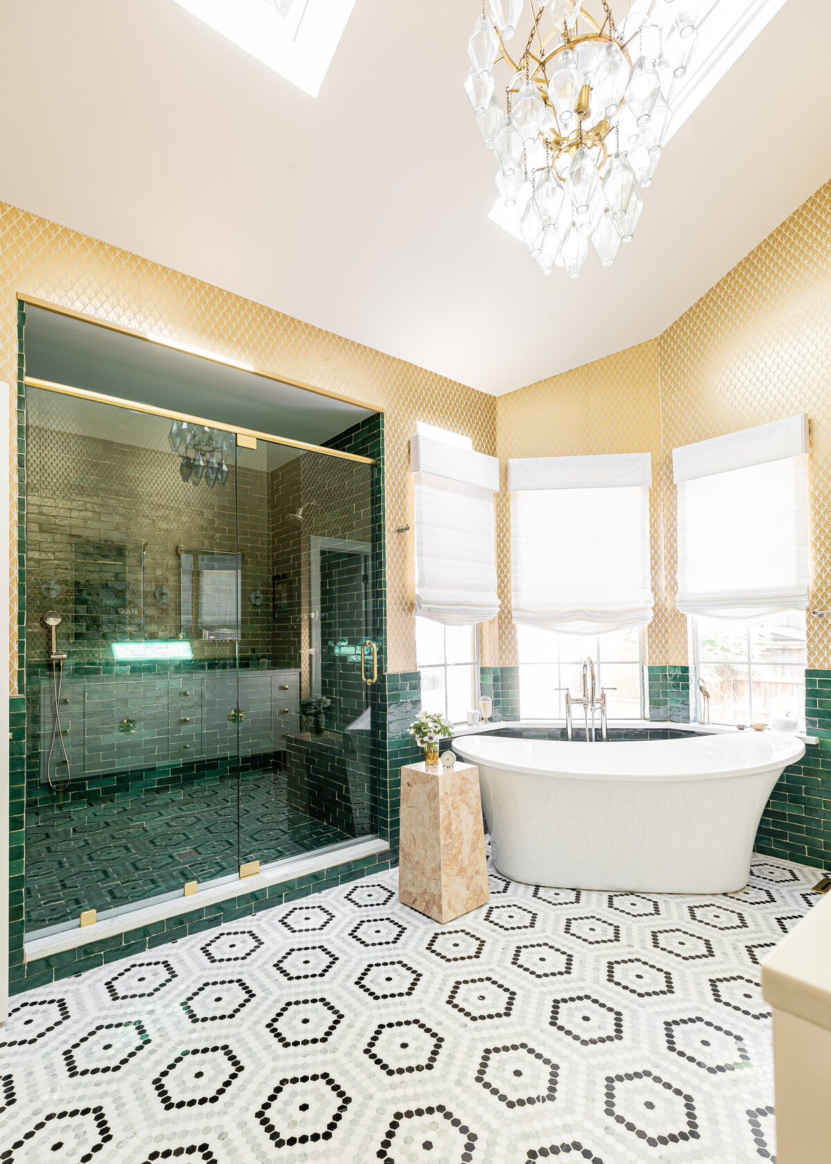 Primary Master Bathroom with Schumacher burnished gilt mugheal leaf wallpaper, emerald green Zellige 2”x6” tile, and black and white hexagon floor tile.