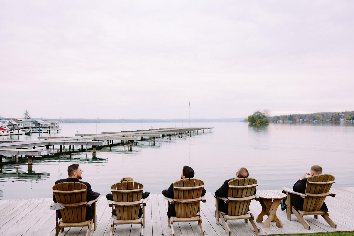 Men sitting on deckchairs looking out onto a lake at The Lake House on Canandaigua