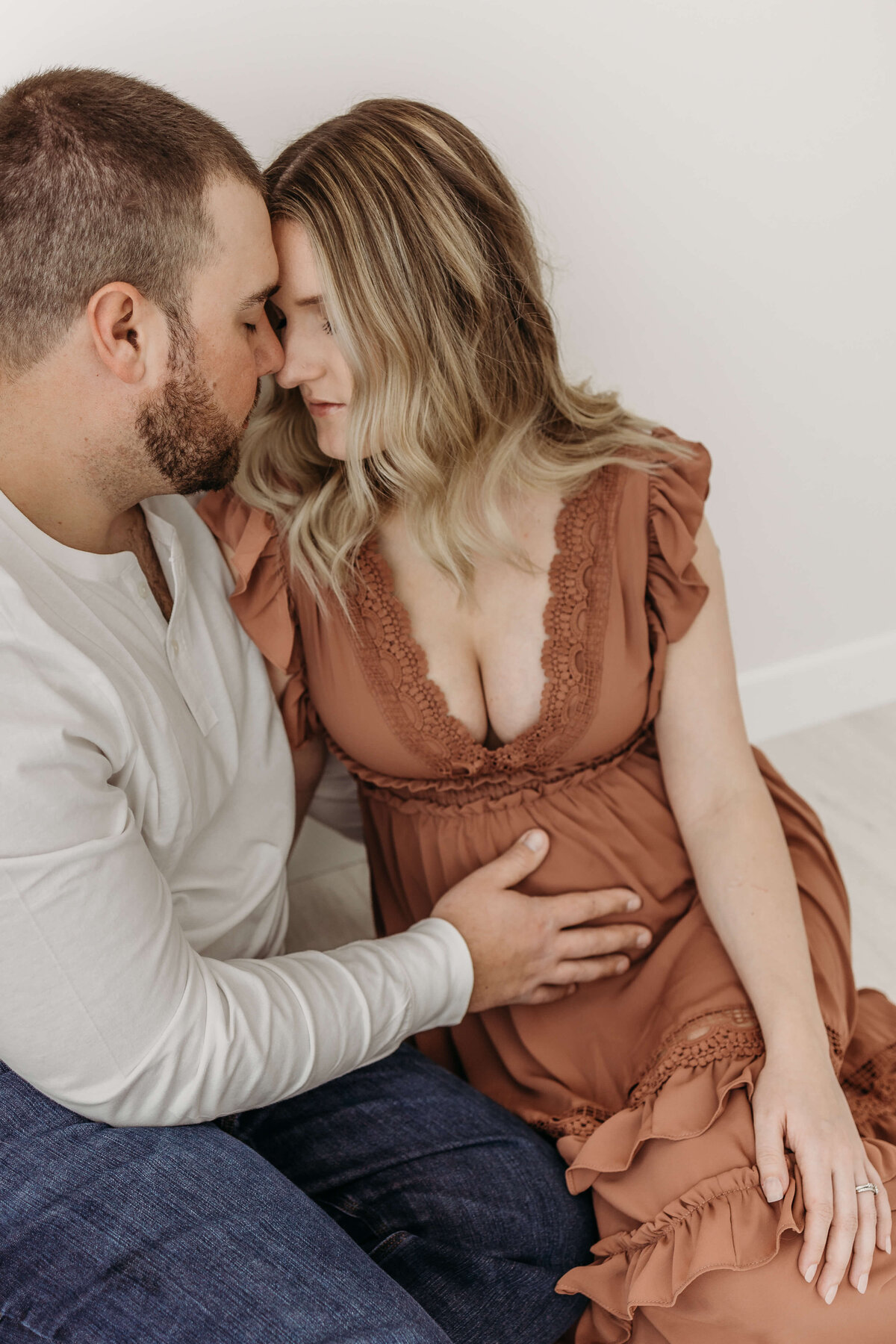 Young couple expecting baby getting cozy on the floor