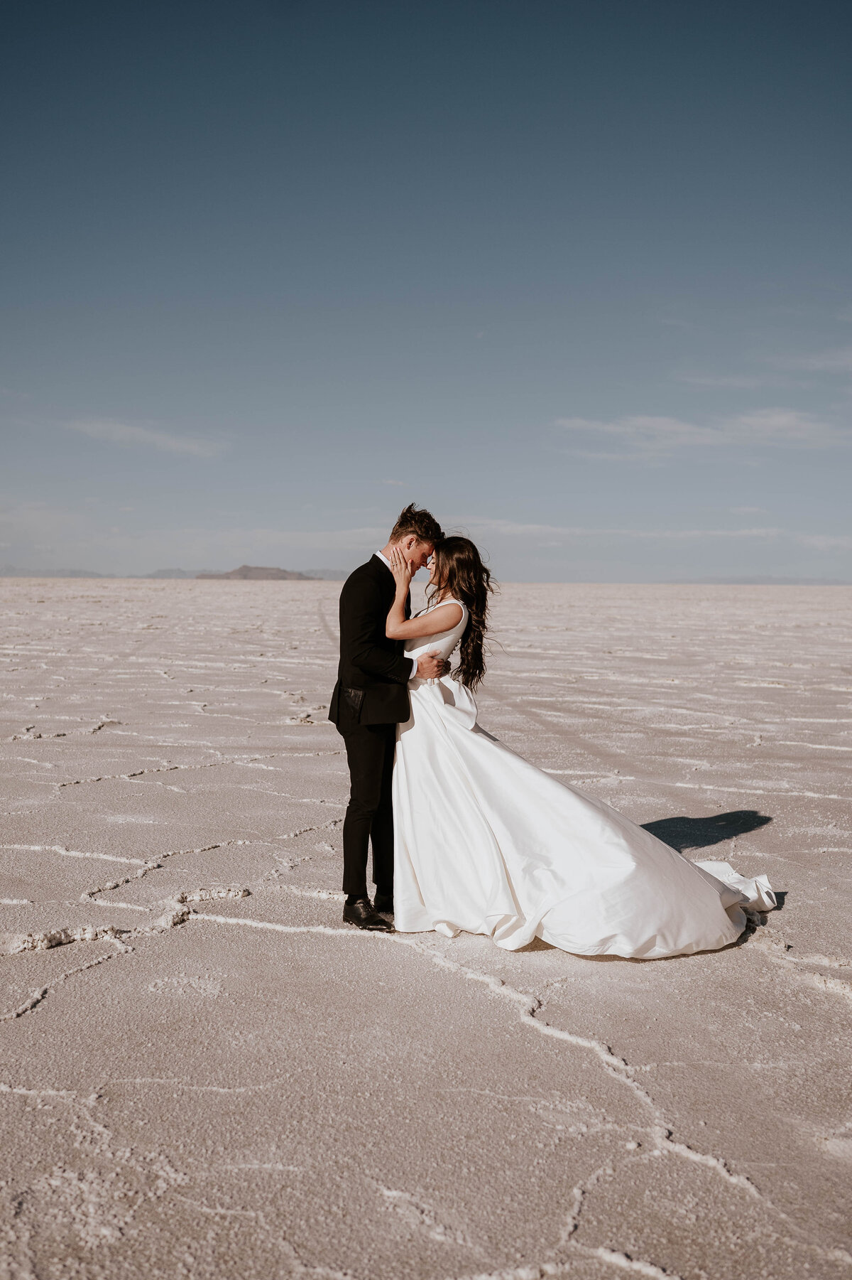 Photograph of couple during their elopement in the sand 