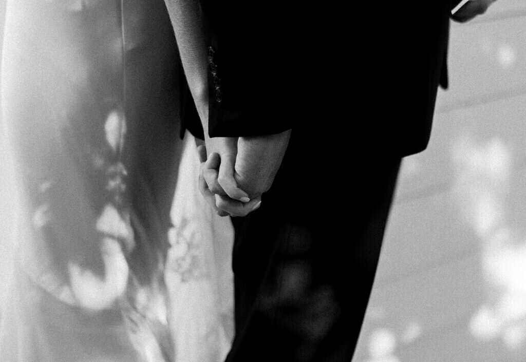 A romantic and intimate first-touch moment as the bride and groom hold hands before their wedding ceremony, filled with anticipation and emotion. Captured by Claudia Amalia Photography, a Florida Keys wedding photographer specializing in destination wedding photography.