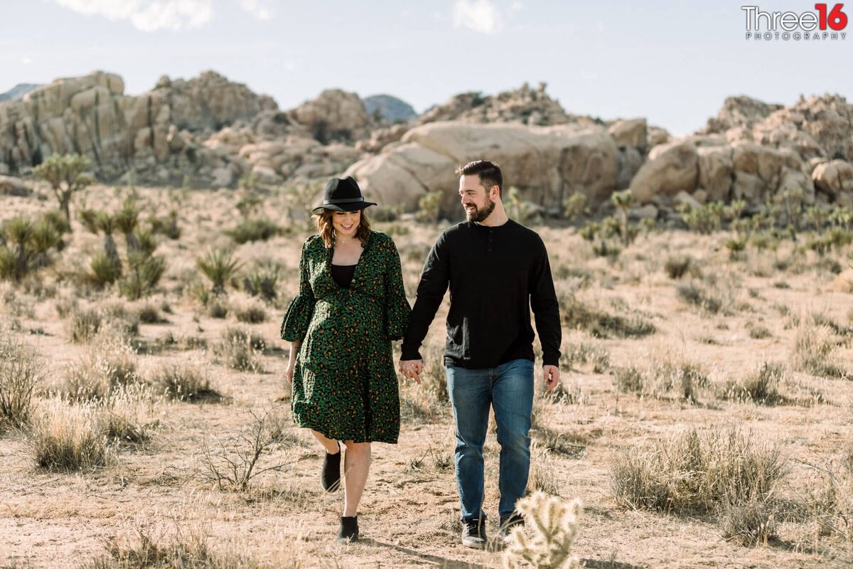 Couple go for a walk holding hands in Joshua Tree National Park