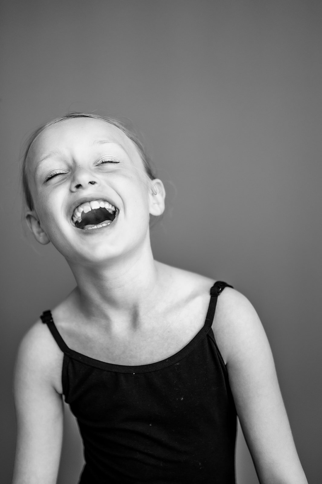 Fine art school photo of a girl smiling softly, captured by a Connecticut school photographer