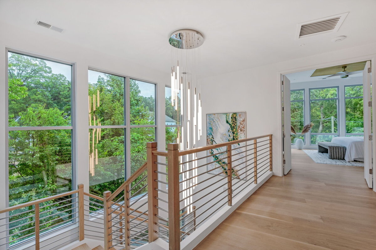 modern stairwell with large chandelier
