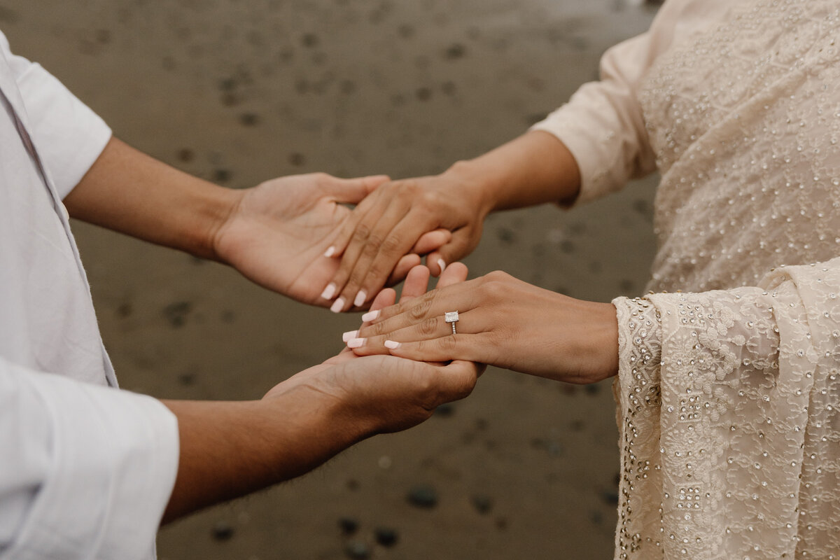 couple holding hands on beach in san francisco