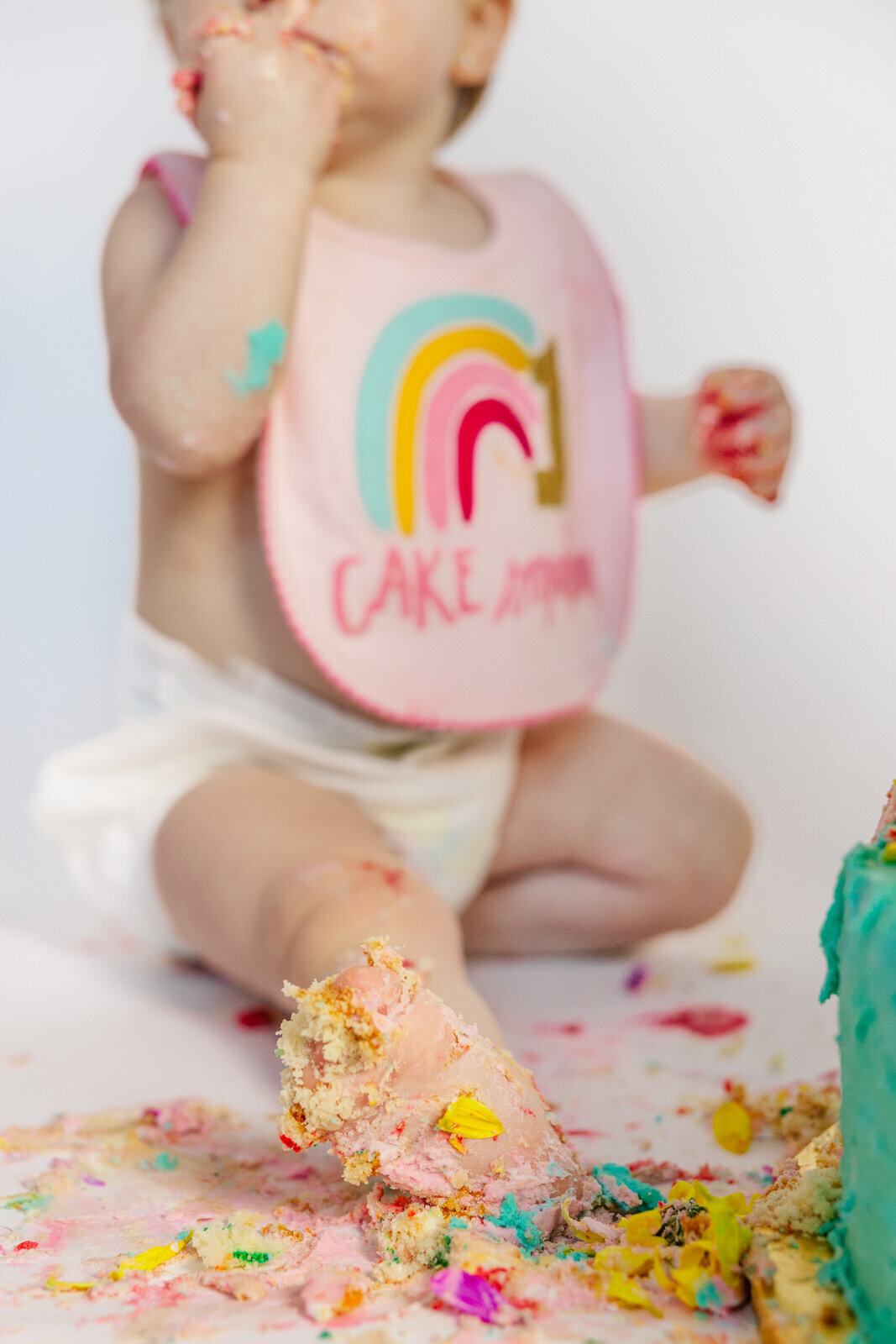 Little girl's foot covered in frosting during her cake smash session