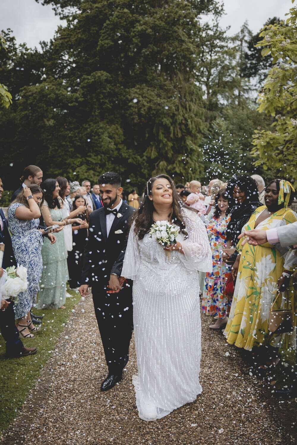 Bride and Groom just married with marital party throwing confetti