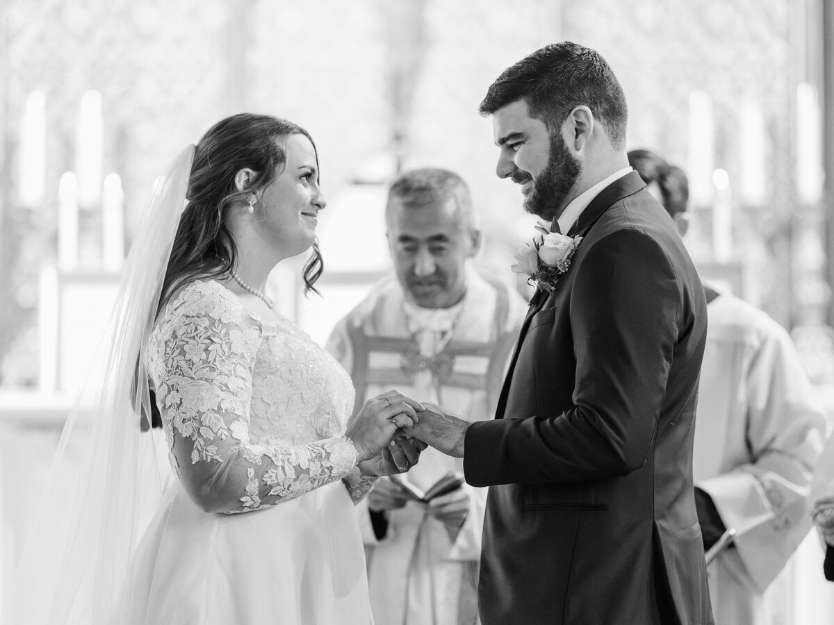 Bride and groom exchange rings during traditional Latin Mass wedding at St Rita Catholic Church in Alexandria, VA