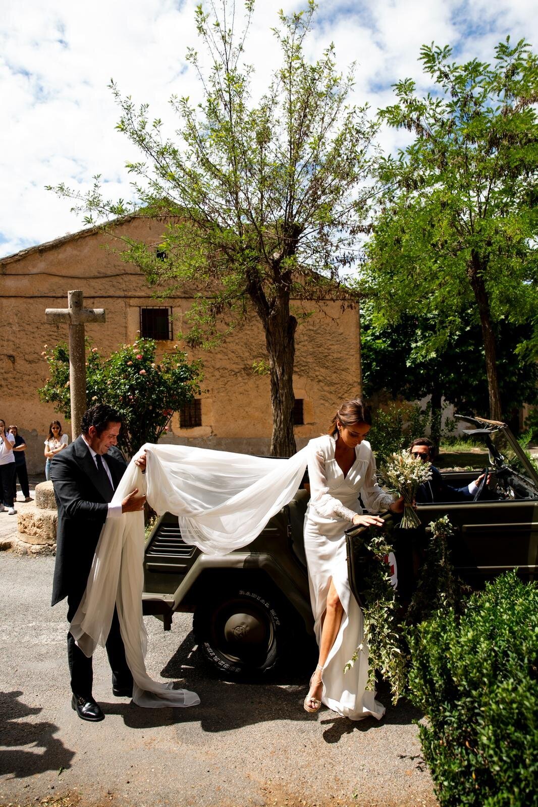 Helping the bride get into the car