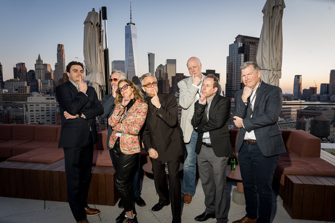 Corporate event photography of group smiling together outdoors with cherry blossoms new jersey.