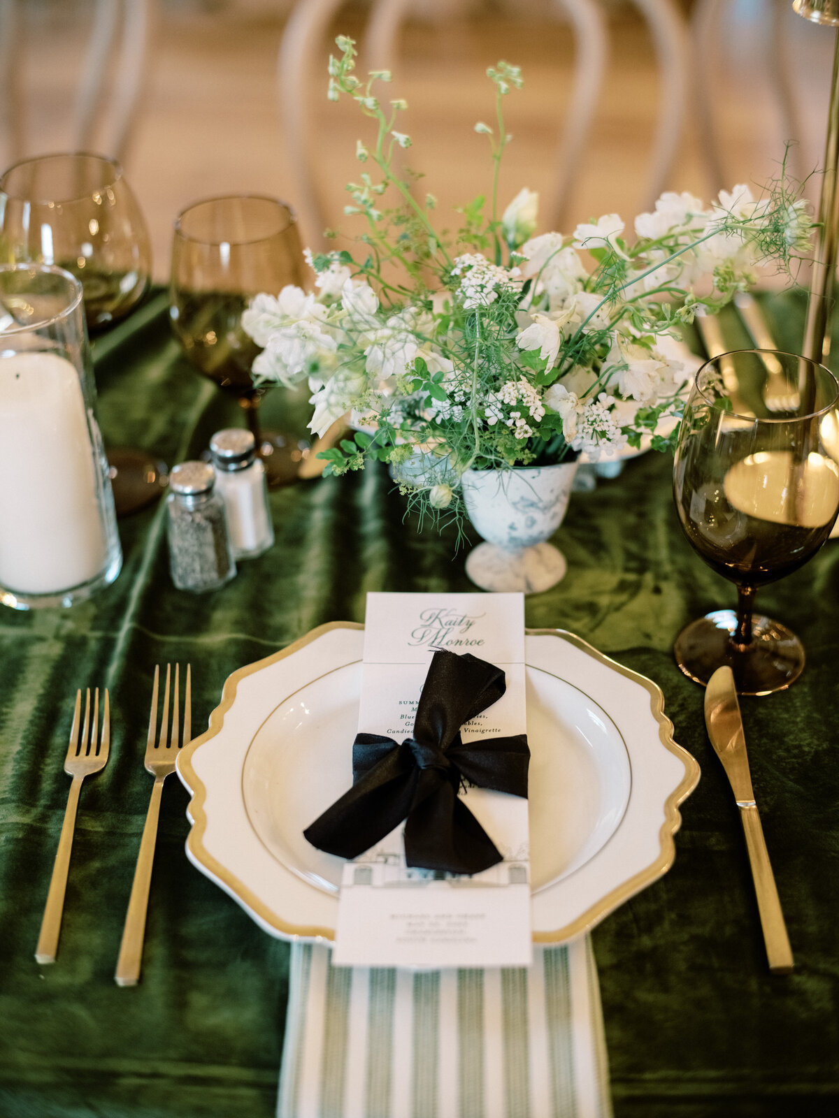A classic dining setup featuring green and white floral decor that enhances the elegance and beauty of the table while inviting an enriching dining experience for all wedding guests.