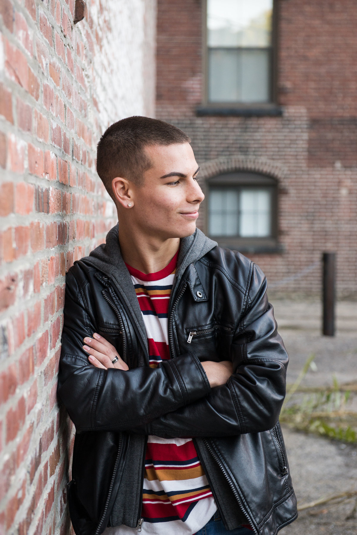 Boy senior photo against brick background