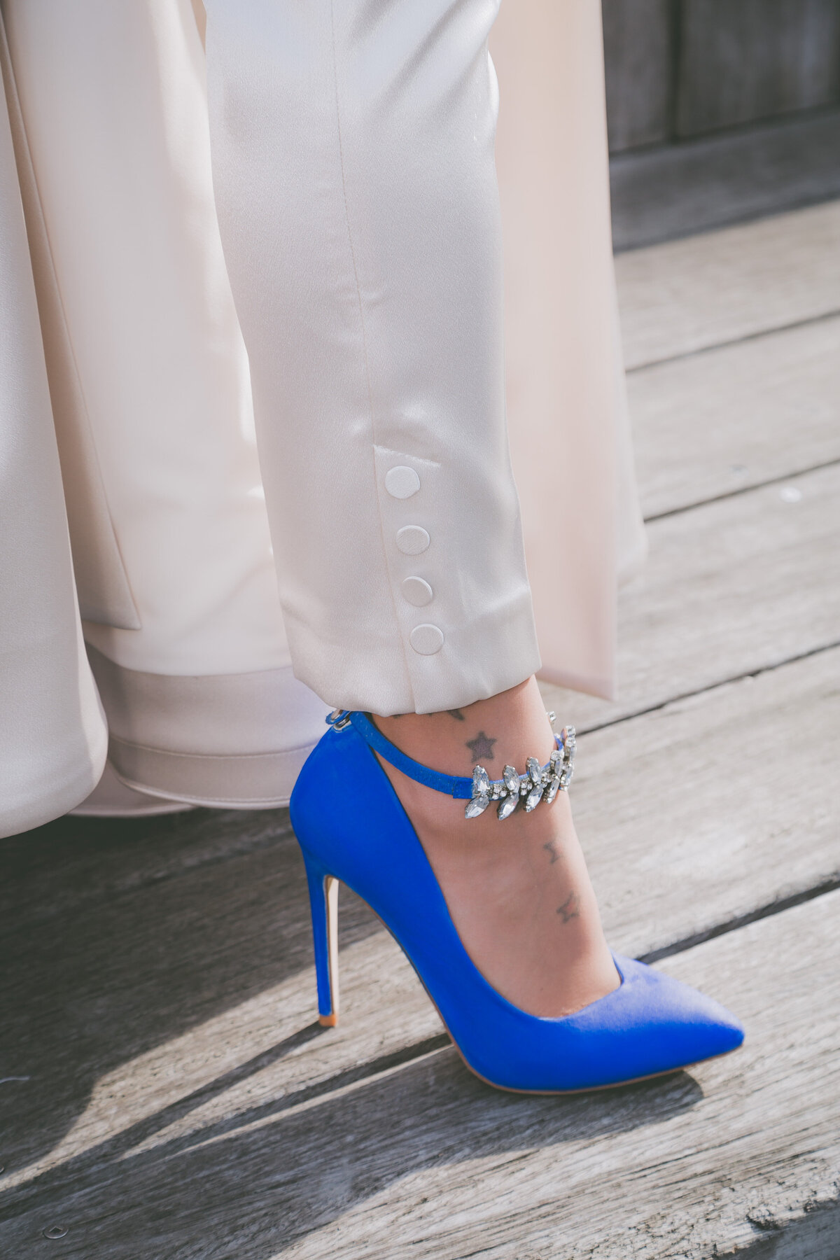 Stylish bride shows off her blue heels.