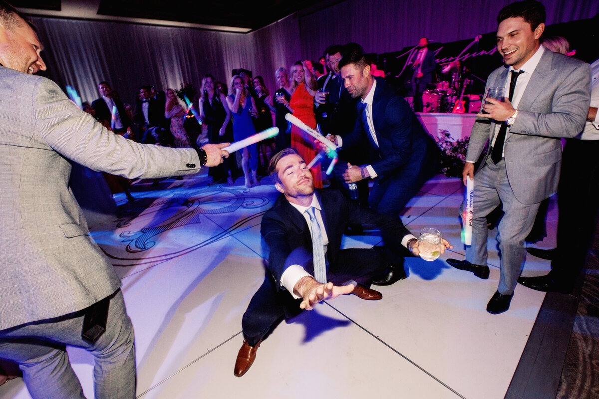 A fun and energetic wedding reception scene with guests dancing, laughing, and enjoying an unforgettable celebration.