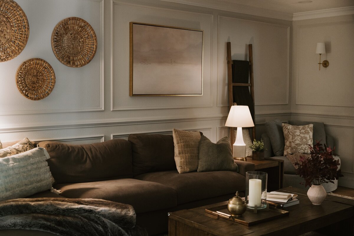 dewine design interiors vintage cove trail living room with brown couch and gold framed picture