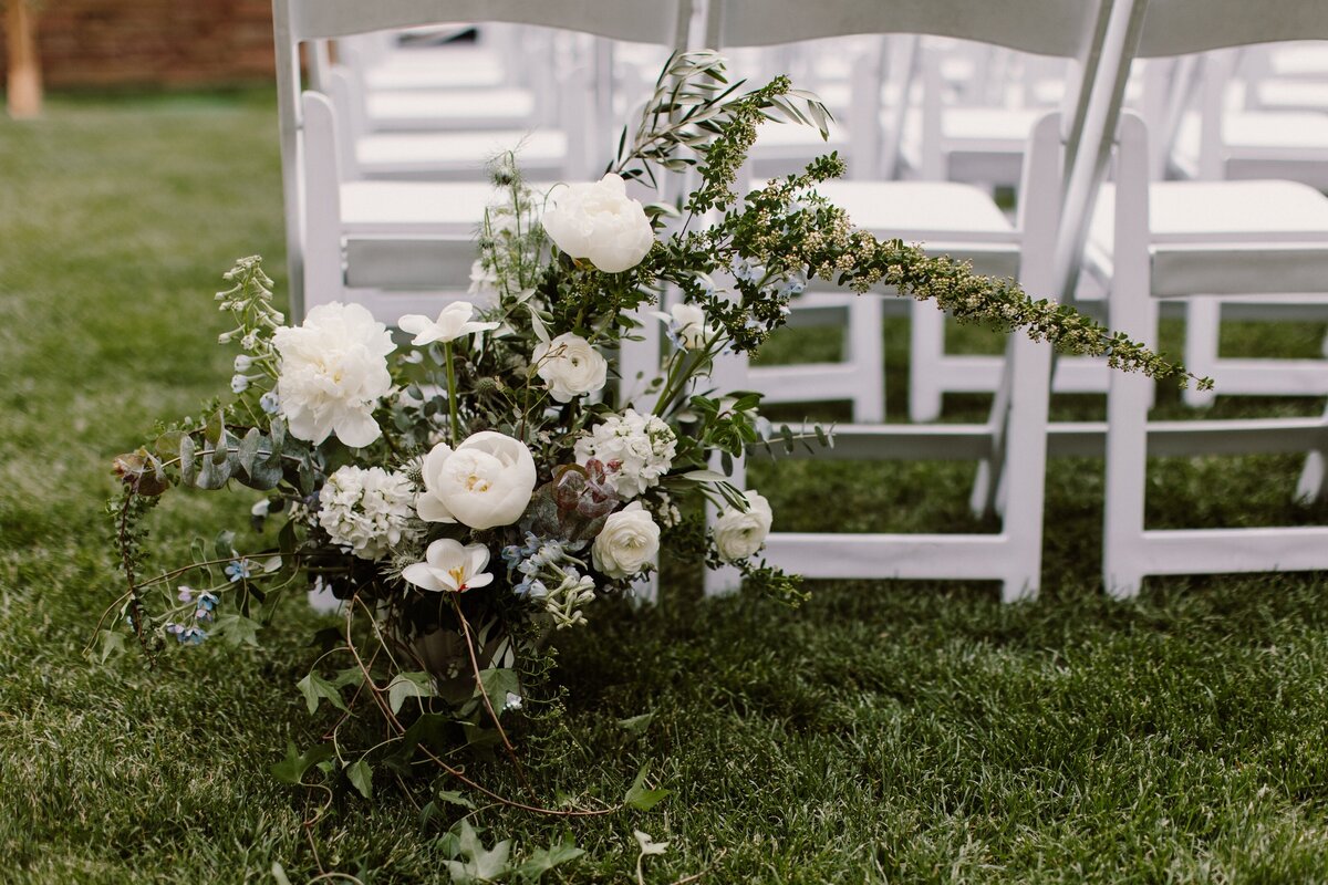 White and greenery wedding ceremony aisle entrance.