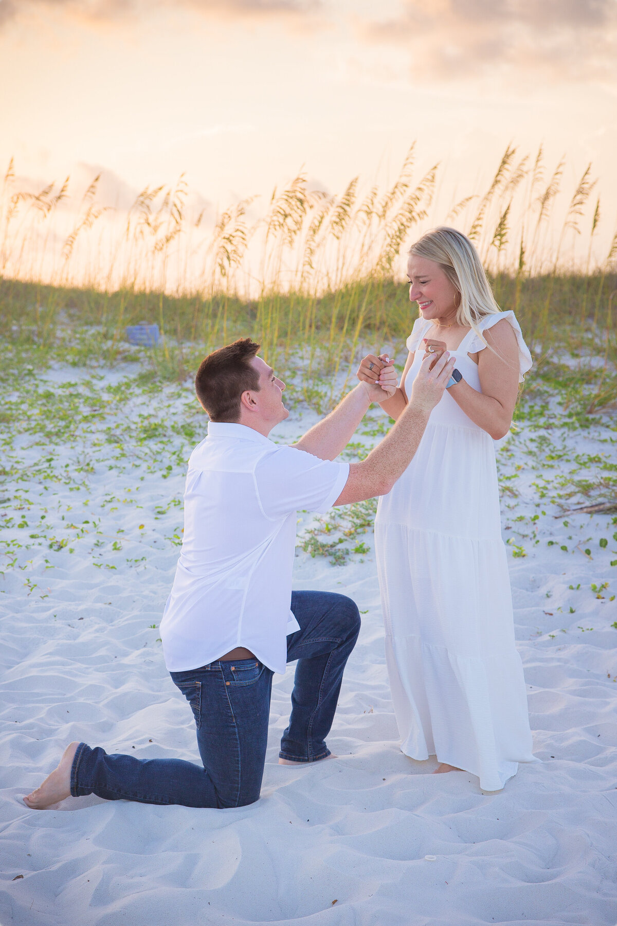 man on knee holding hands during proposal