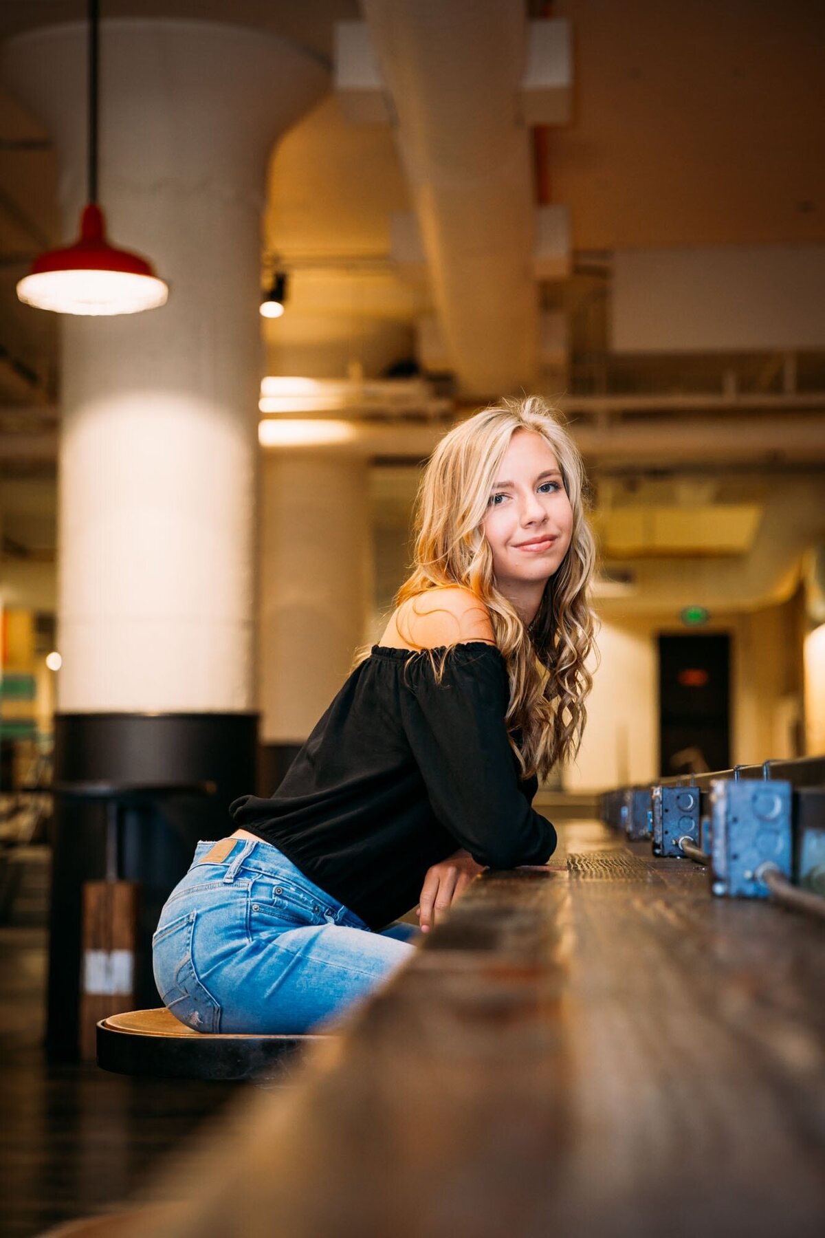 Senior portrait of a girl sitting at a coffee bar in Ponce City Market in Atlanta.