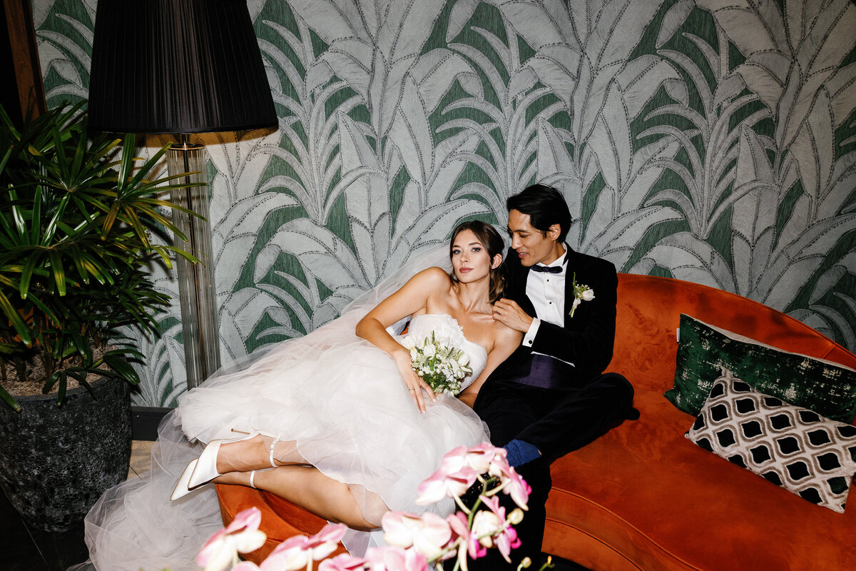 Bride and groom embracing with bride's backless dress and groom holding bouquet, taken by Claudia Amalia, Miami and Florida Keys wedding photographer.