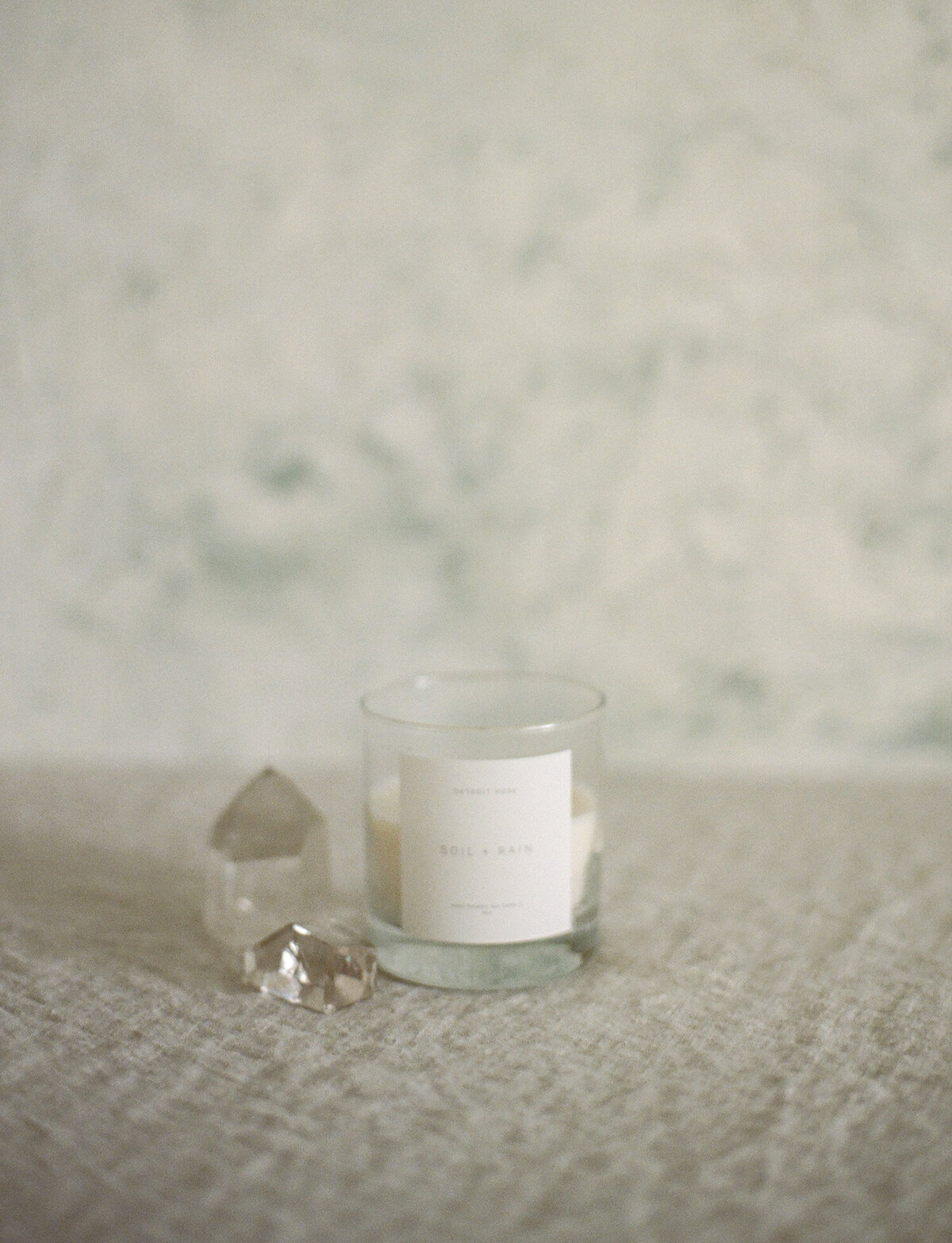 Detroit Rose Soil + Rain candle with painterly backdrop, crystal, candle branding photo