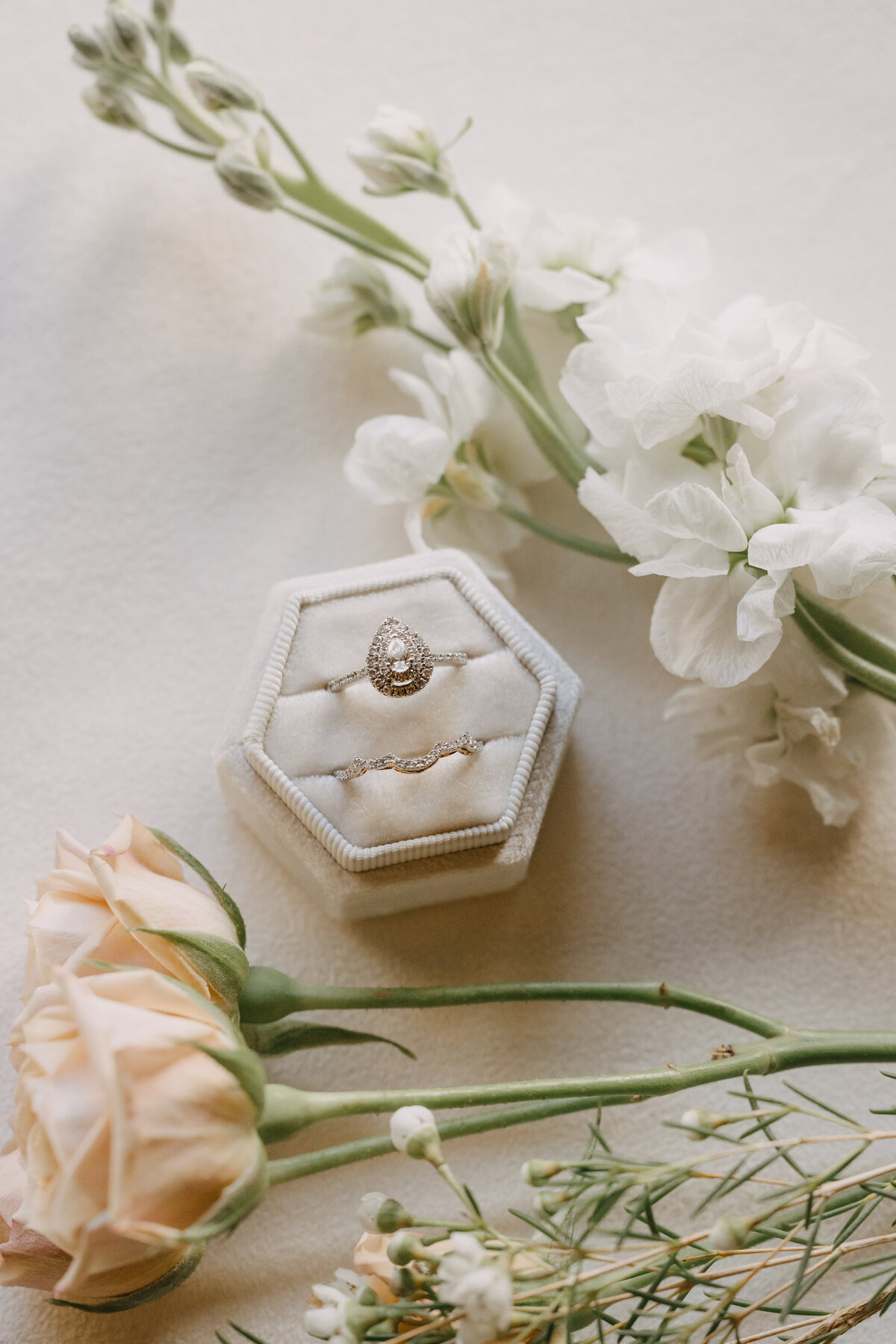 Detail shots of the bride's wedding ring surrounded by flowers