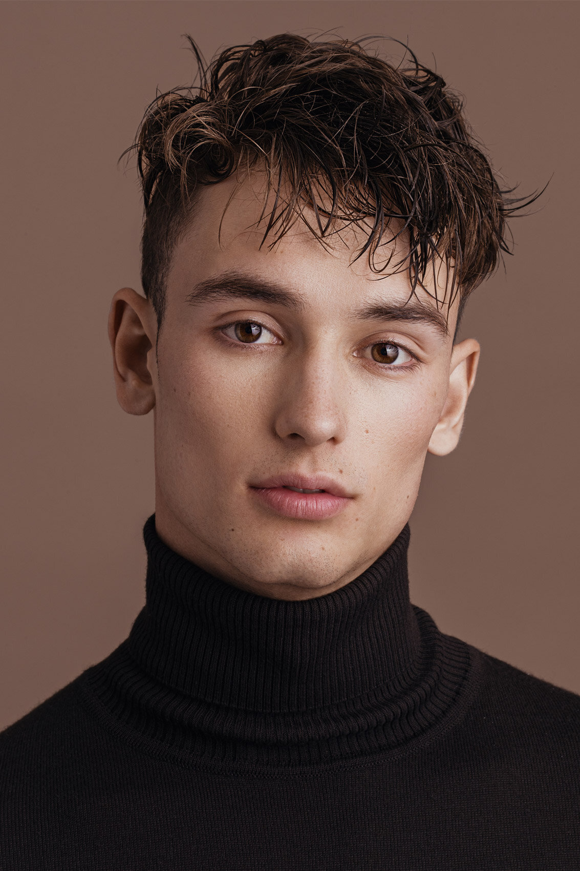 Close-up portrait of Vlad Starun wearing a black turtleneck, with a calm and poised expression, photographed by Ylva Erevall.