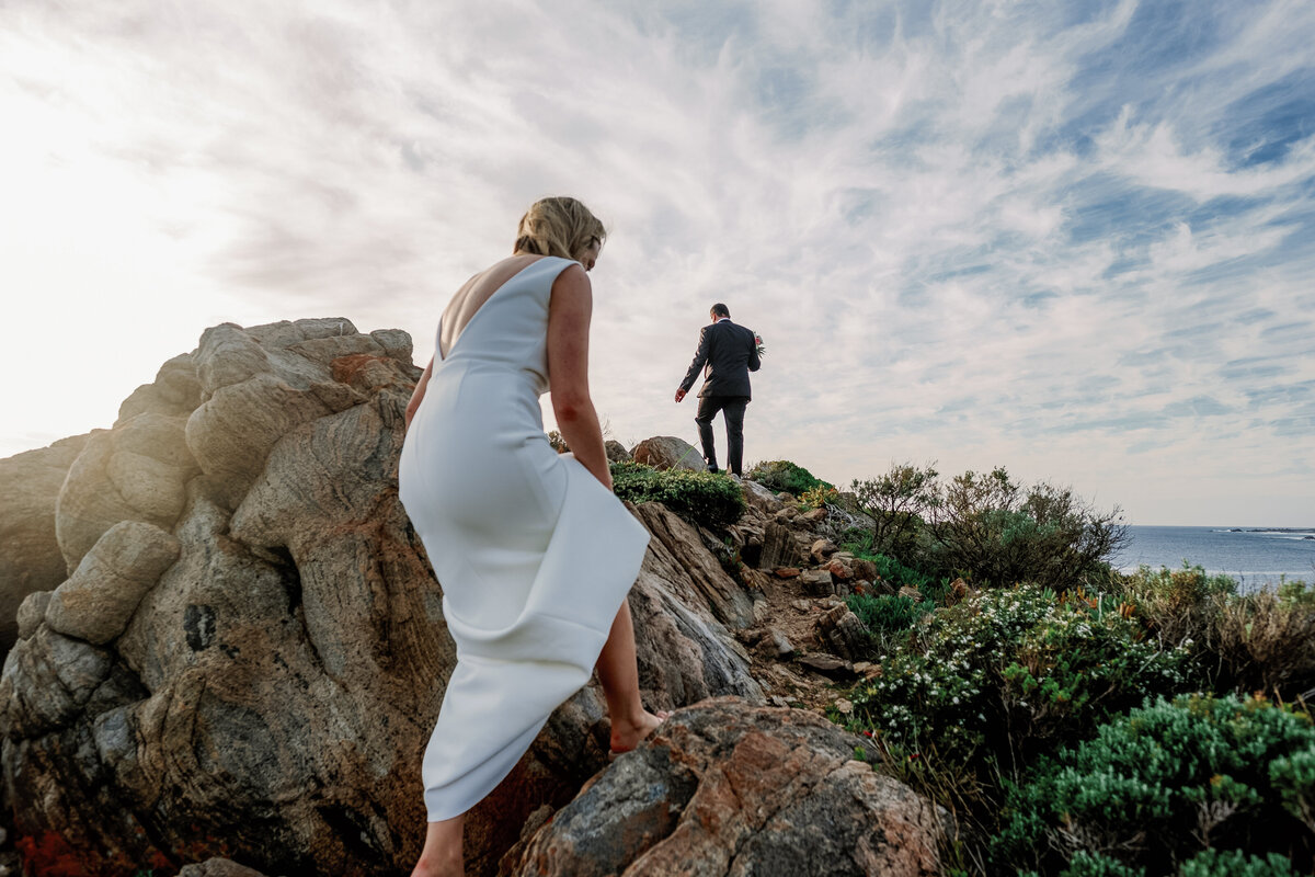 Wedding couple climbing Sugar Loaf Rock in Perth Australia