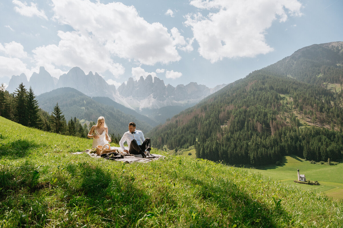 Scenic view of Dolomites peaks behind bride and groom