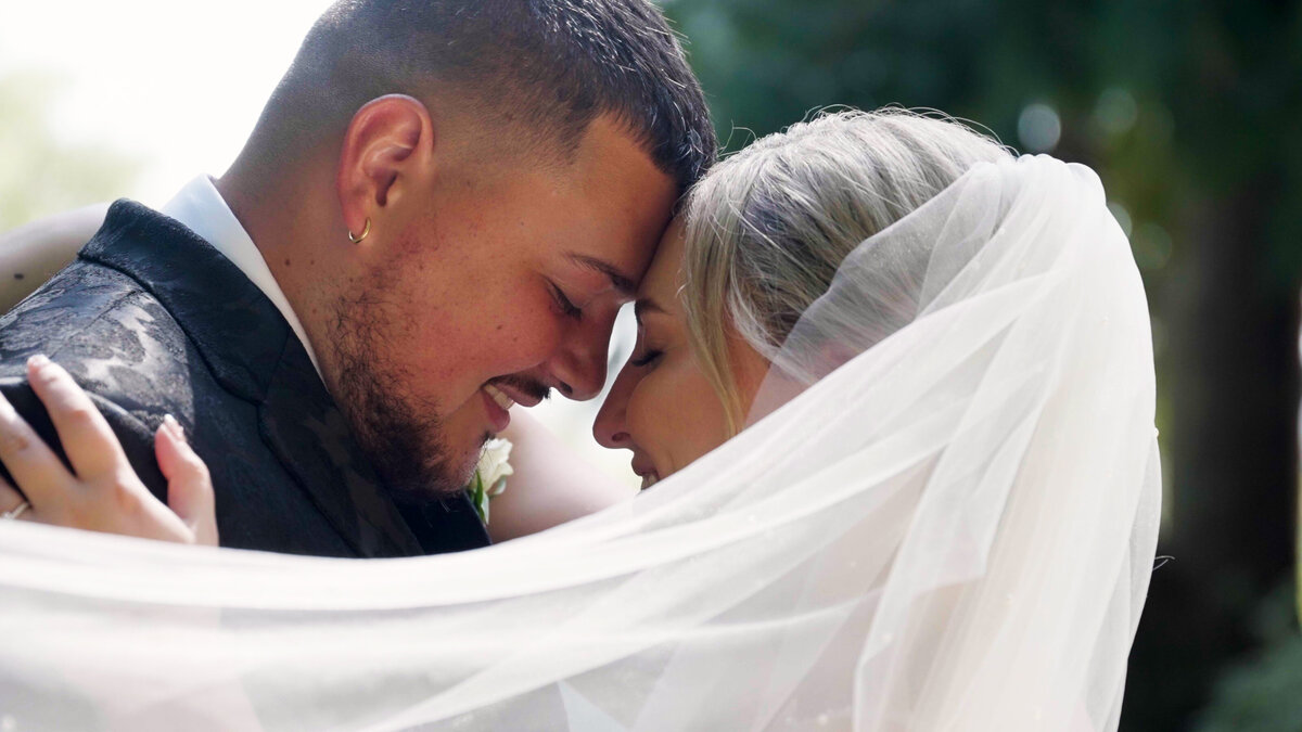 bride and groom embracing and smiling