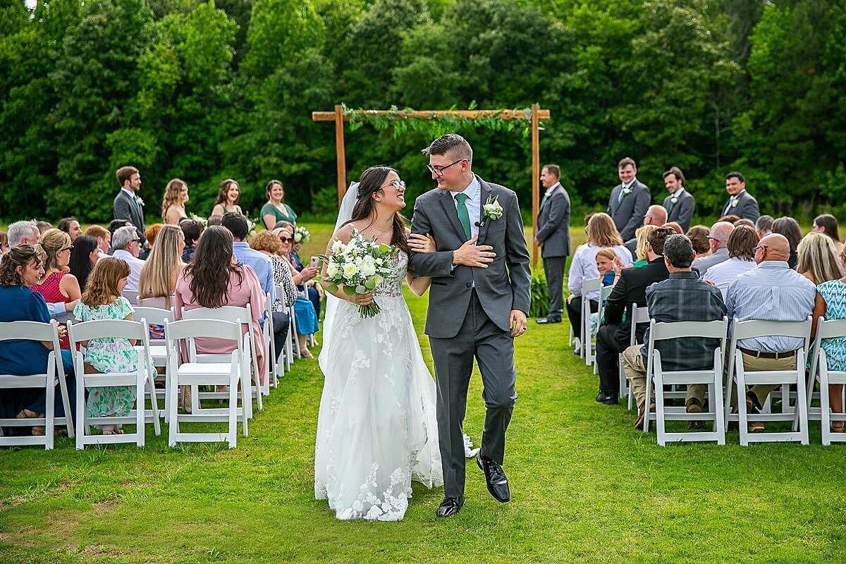 Bride-Groom-Walking-Isle-Ceremony-Arbor-The-Legacy-at-Willow-Pond-Wedding-Virginia.JPG