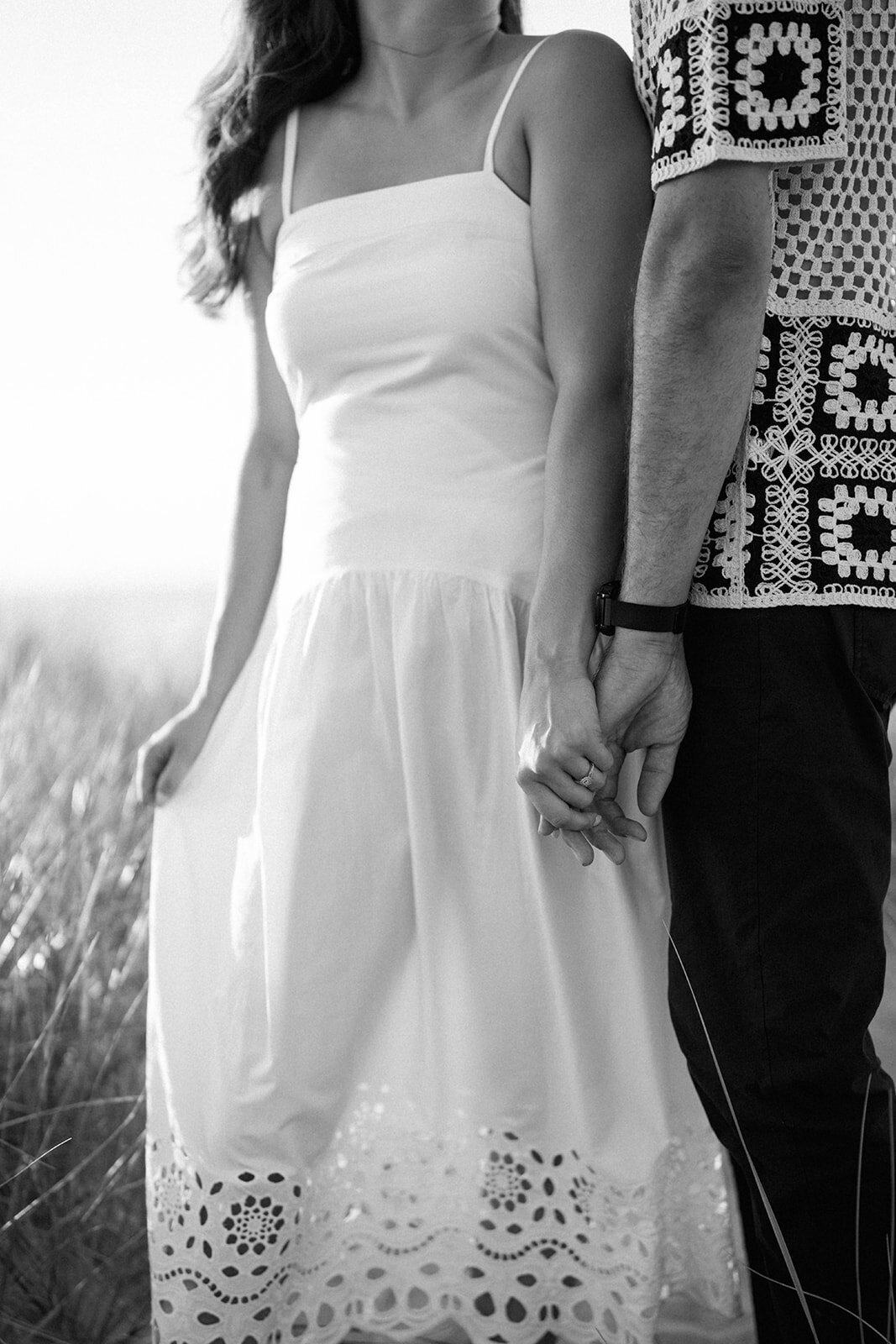 Close-up of bride-to-be’s white dress during coastal engagement photos at New Buffalo Beach in Michigan