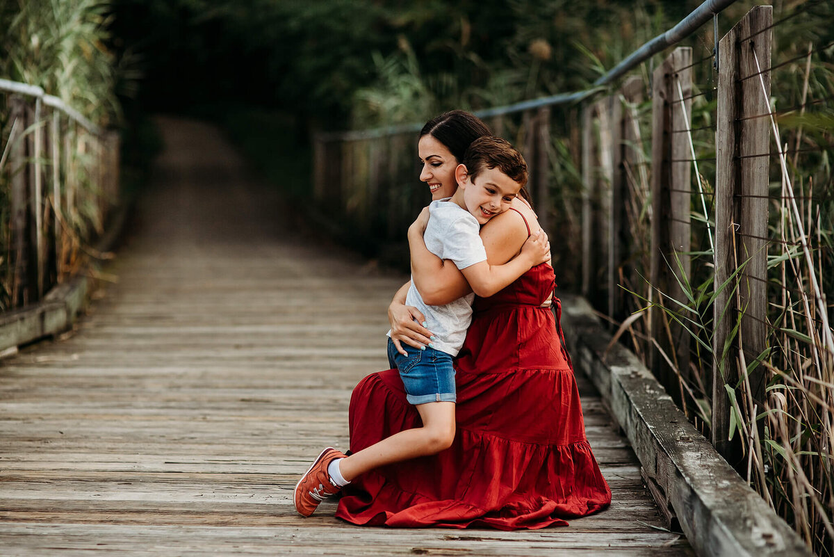 Mother hugging son on a bridge near Washington DC