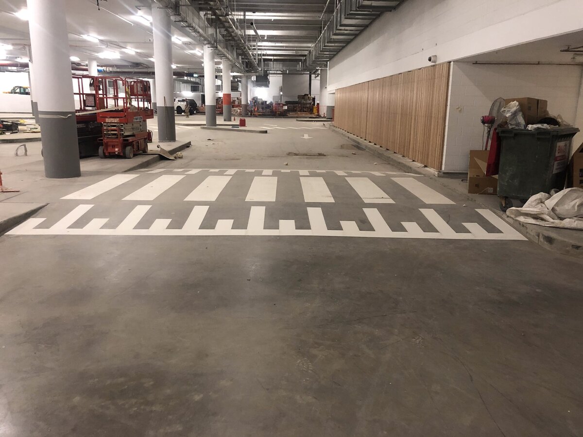 Line marking of a pedestrial crossing within a carpark.