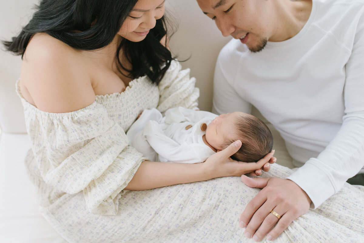 modern northern virginia parents holding newborn baby at lifestyle photography session