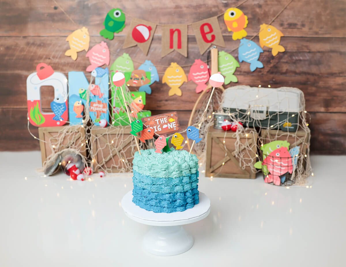 A fishing-themed cake and decorations during a custom cake smash photoshoot in Rochester, NY.