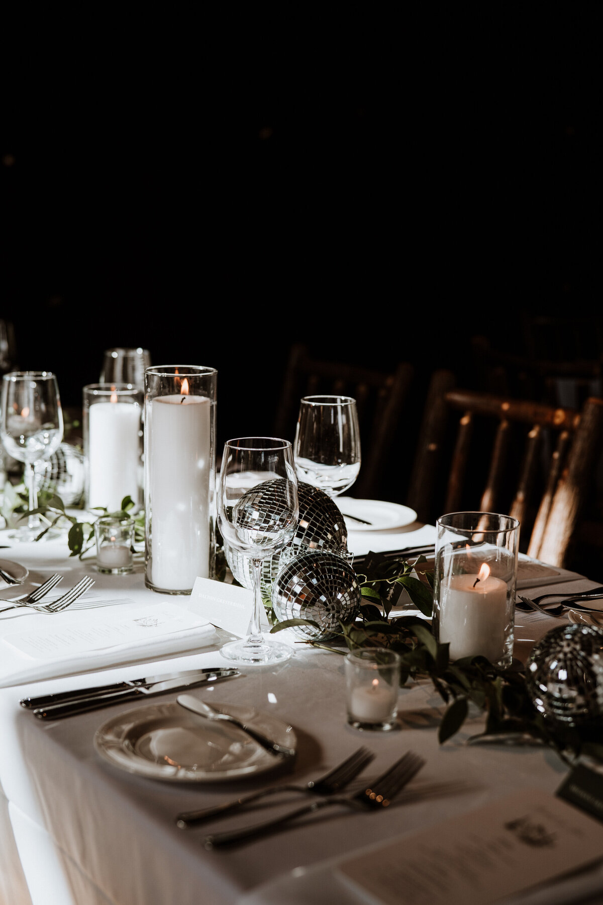 Modern wedding table setup with disco balls, candles, and glassware at Breckenridge venue, Ten Mile Station.