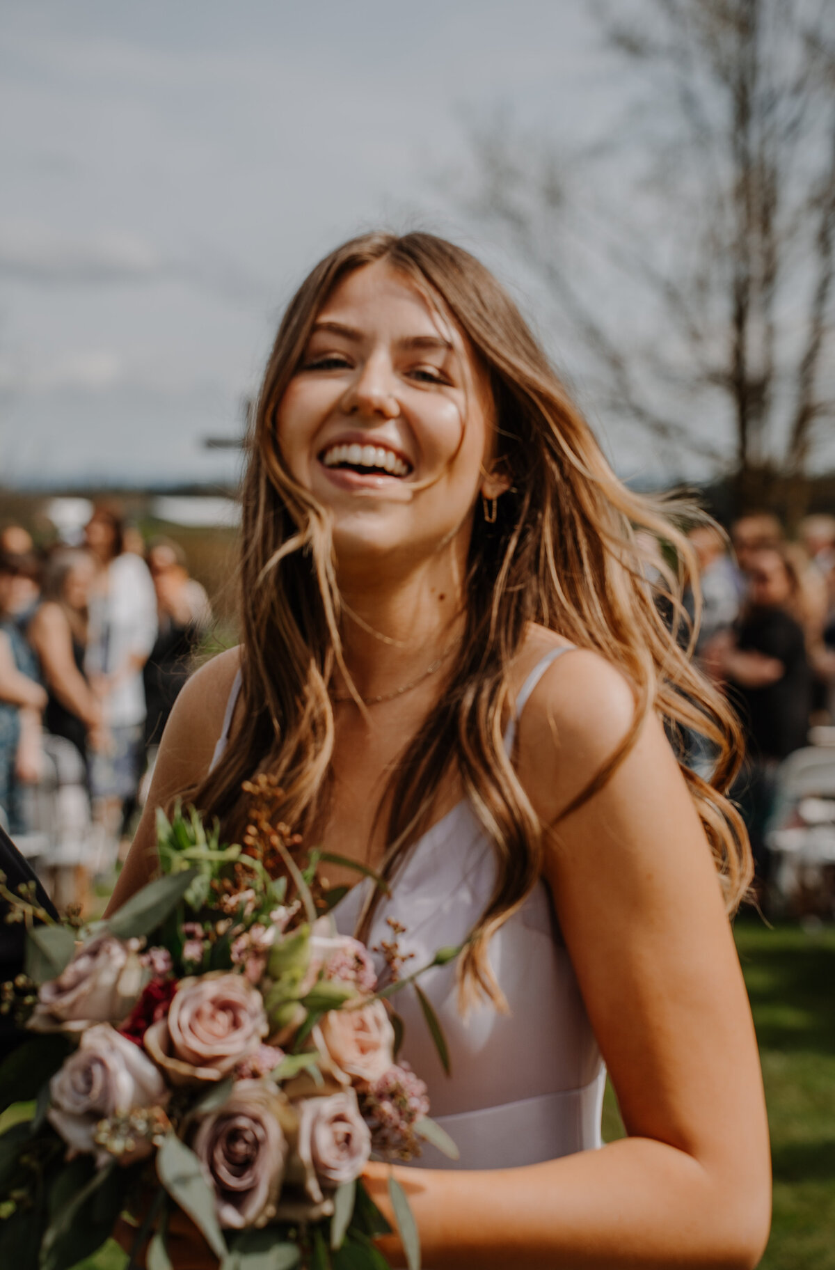 Bridesmaid smiling with windblown hair