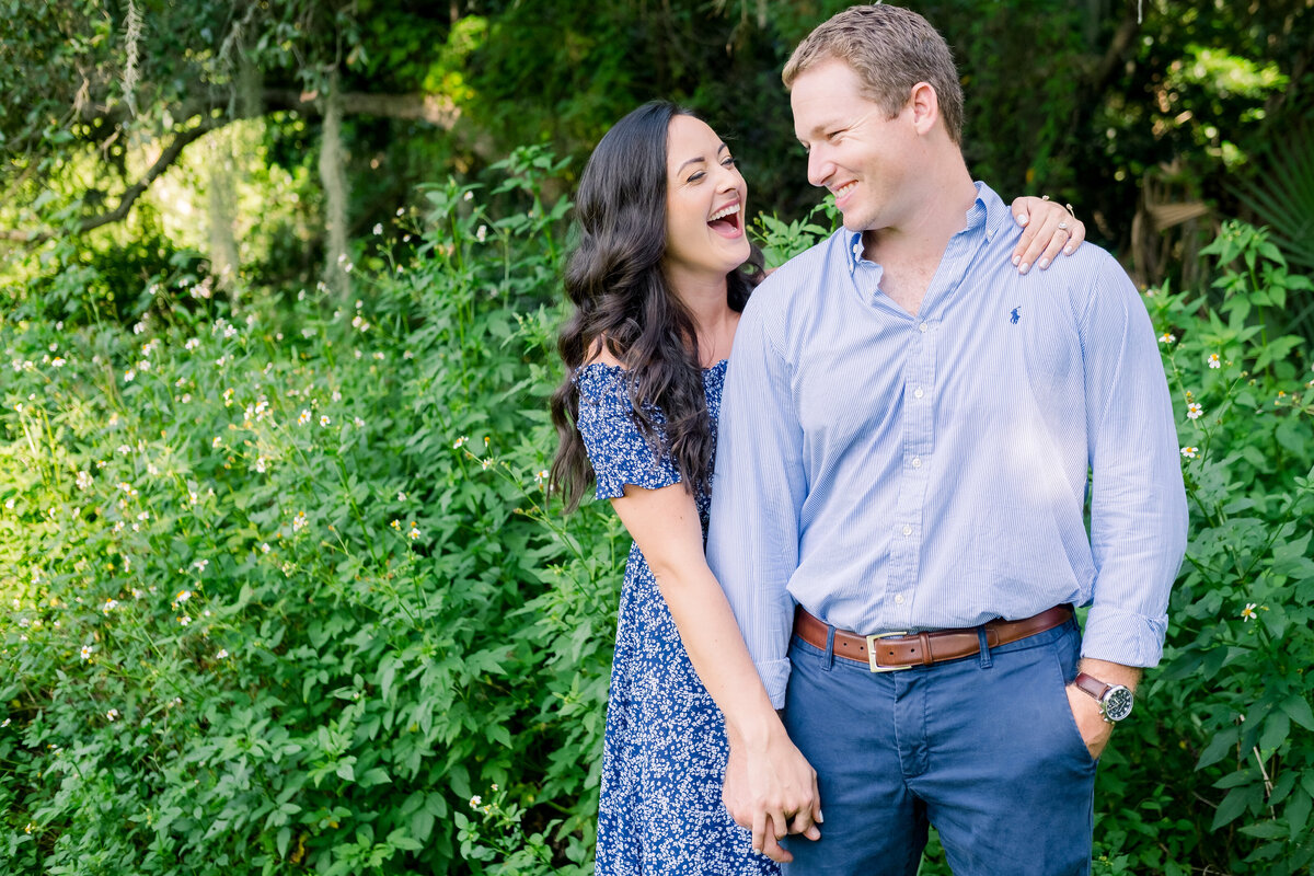 Fiance holds hands and laugh during Philippe Park engagement session
